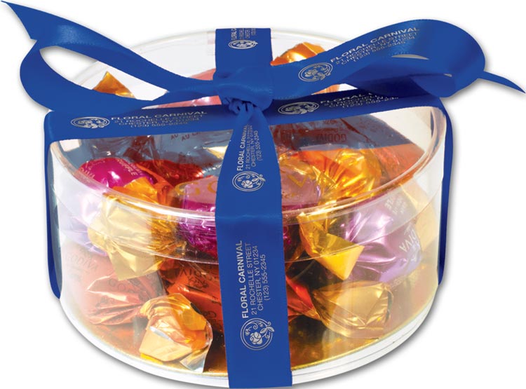 Clear gift box filled with Godiva chocolates and your business name on blue ribbon around it. Use as holiday gift.